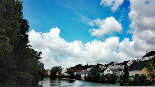 Panoramic view of river amidst city against sky