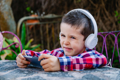 Cute boy listening music on headphones