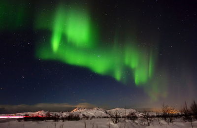 Scenic view of landscape against sky at night during winter