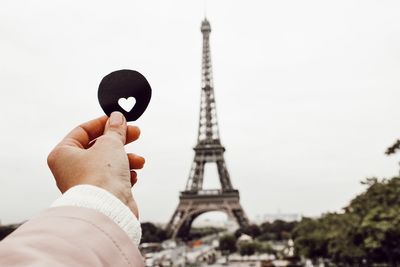 Low angle view of hand holding tower