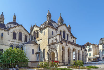 Low angle view of buildings against clear blue sky