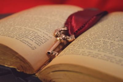 Close-up of open book with skeleton key