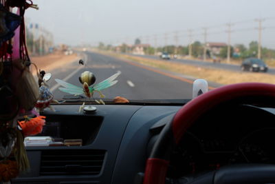 Cars on road seen through car windshield