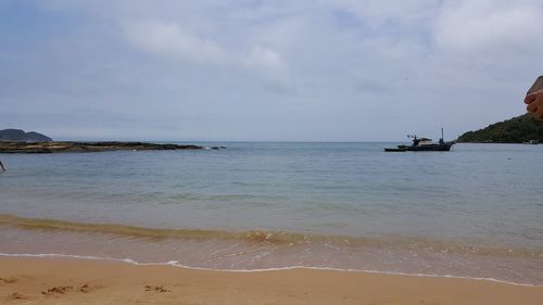 View of calm beach against the sky