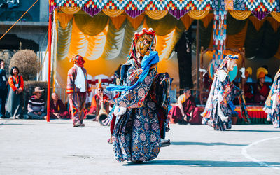 People in traditional clothing dancing in temple