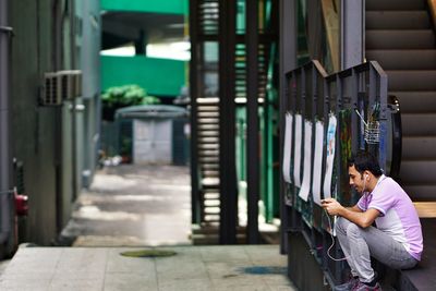 Side view of man using mobile phone