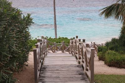 Boardwalk on beach against sky