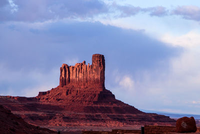 Rock formations against cloudy sky