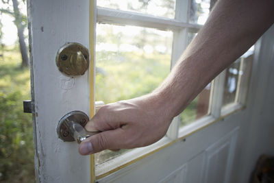 Man's hand holding door handle