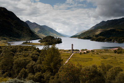 Scenic view of lake and mountains against sky