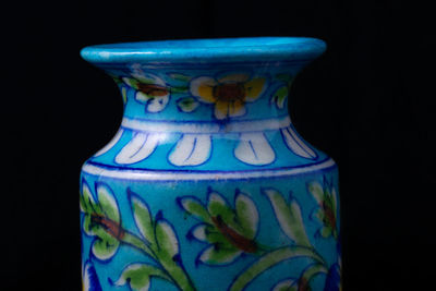Close-up of multi colored vase against black background