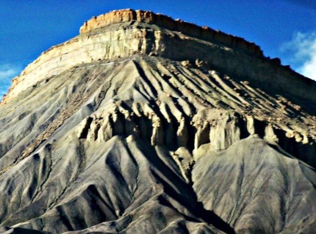 low angle view, sky, travel destinations, famous place, rock formation, desert, tranquility, blue, mountain, physical geography, sunlight, ancient civilization, built structure, nature, travel, geology, day, arid climate, outdoors, tourism