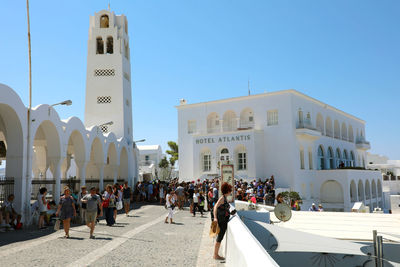 Group of people in front of buildings in city