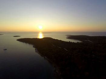 Scenic view of sea against clear sky during sunset