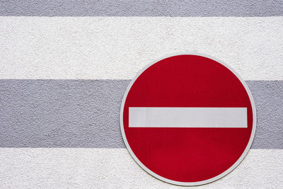 Close-up of road sign against built structure