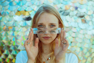 Portrait of young woman holding crystals