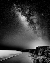 Scenic view of sea against sky at night with the milky way