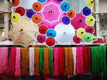 Multi colored clothes hanging for sale in market