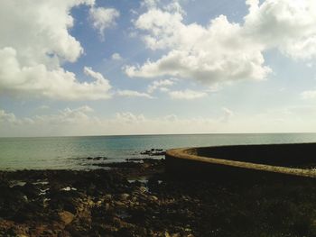 Scenic view of sea against cloudy sky