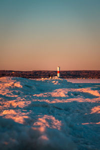 Sunset at the lighthouse in petoskey michigan in winter