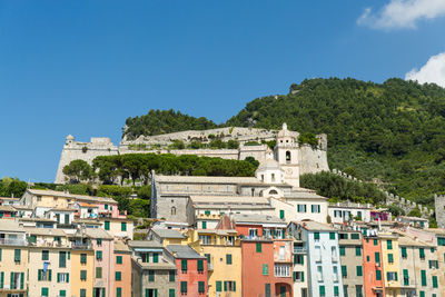 Buildings in city against blue sky