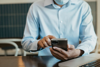 Midsection of woman using mobile phone