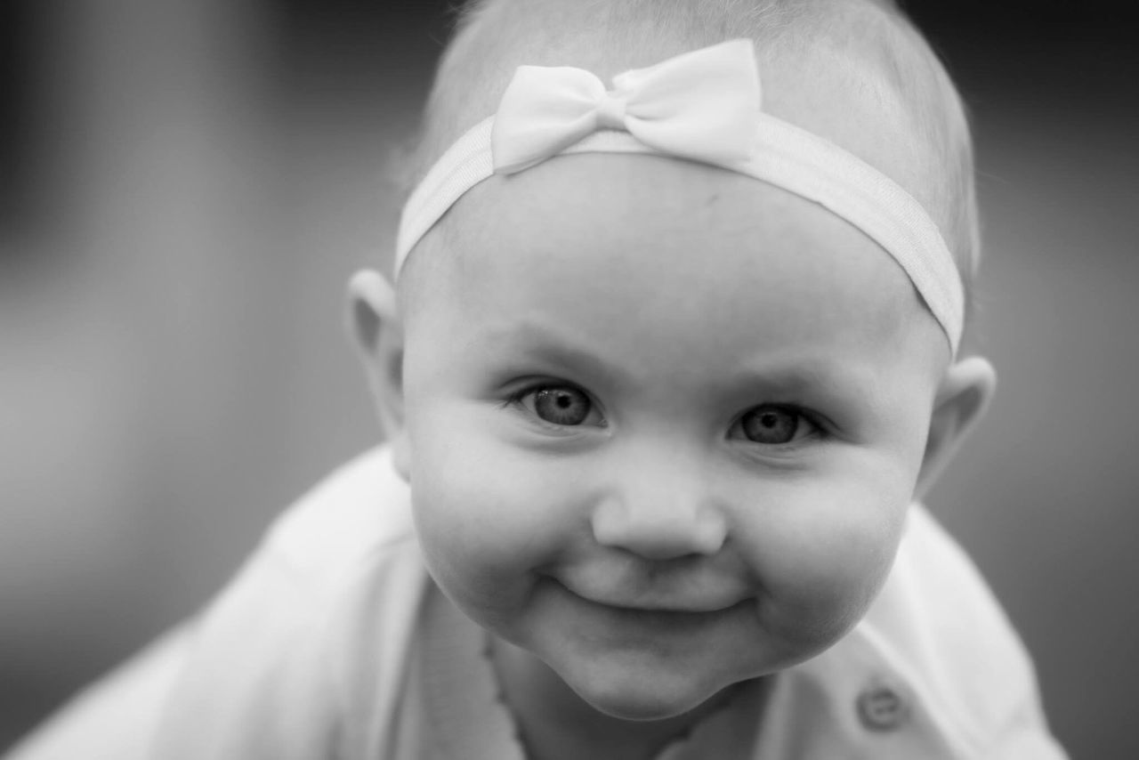 cute, looking at camera, childhood, portrait, innocence, real people, happiness, smiling, focus on foreground, front view, one person, lifestyles, close-up, headshot, indoors, day, people