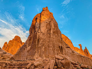 Low angle view of rocky mountain against sky