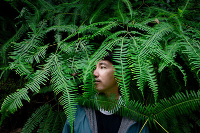 Portrait of teenage girl on plant