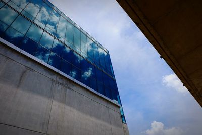 Low angle view of modern building against blue sky