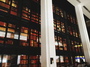 Low angle view of illuminated books in library