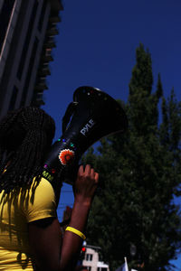 Low angle view of woman against sky