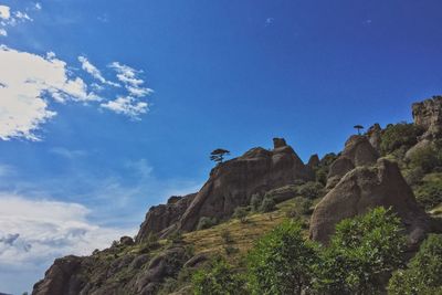 Low angle view of mountain against blue sky