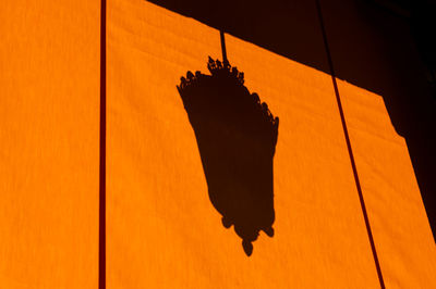 Shadow of street light on orange awning