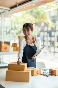 Portrait of smiling entrepreneur working at shop