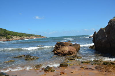 Rocks on beach against sky