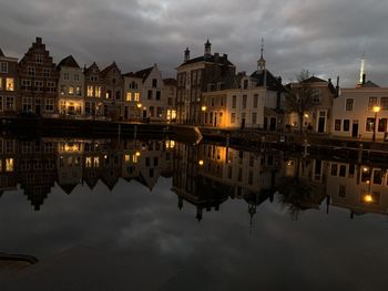 Reflection of buildings in lake at night