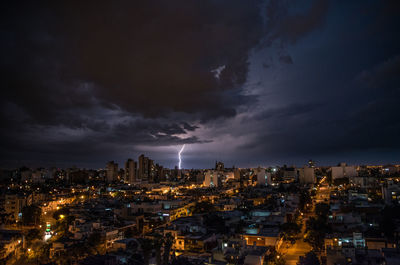 Aerial view of illuminated city against sky at night