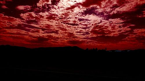 Silhouette landscape against scenic sky