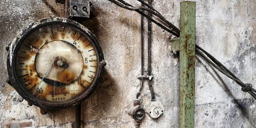 Close-up of old clock on wall