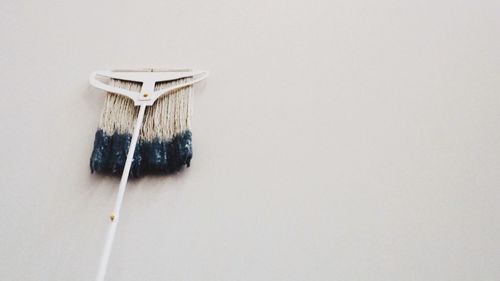 Close-up of wooden object over white background