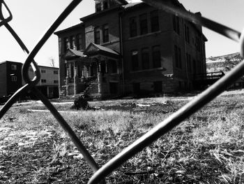 Railroad tracks amidst buildings against sky