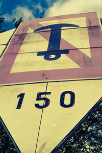 Low angle view of information sign against sky