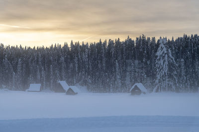 Scenic view of snow covered land against sky