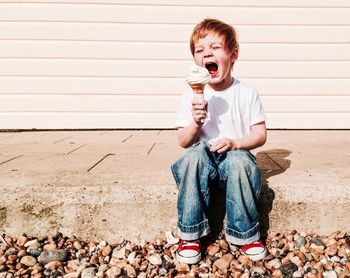 Boy eating ice cream outdoors