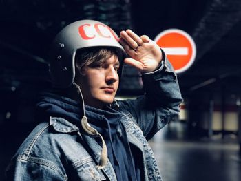 Portrait of teenage boy holding camera