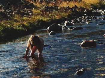 Young woman swimming in river