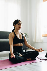 Portrait of young woman exercising in gym