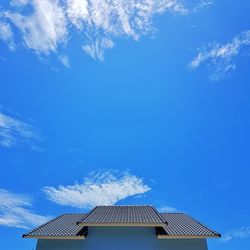 Low angle view of traditional house against blue sky