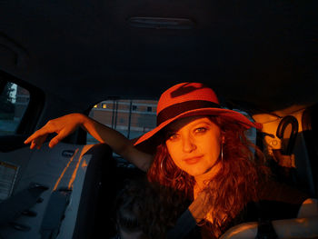 Portrait of young woman in car